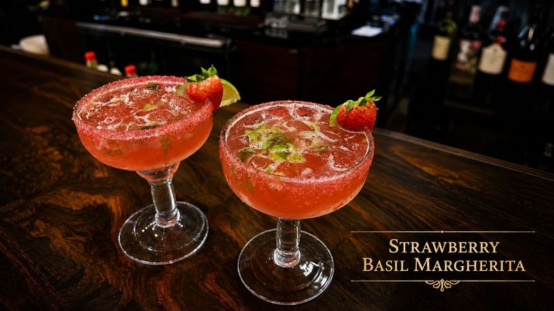 Two strawberry basil margaritas with sugar rims